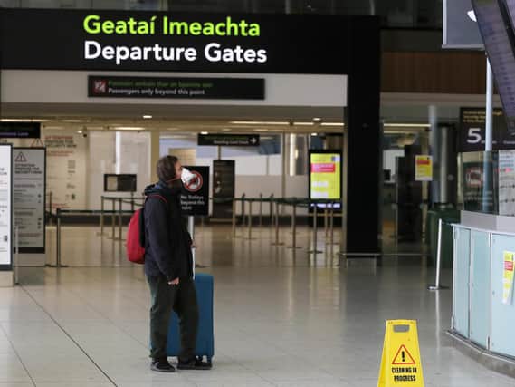File photo dated of a man wearing a protective face mask in the departures area of terminal one at Dublin airport. Aer Lingus has announced details of a replacement flights schedule after operator Stobart Air ended its contract with the Irish airline.