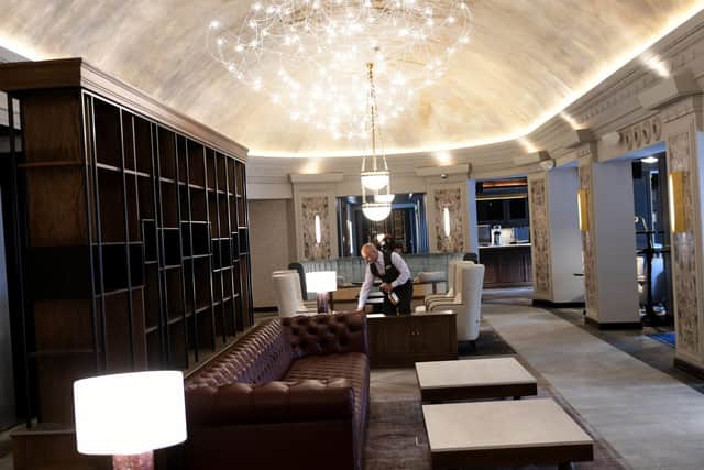 Dav Singh a Concierge at the Queens Hotel In Leeds, getting the new Cafe Pacific in the entrance to the hotel ready for reopening.