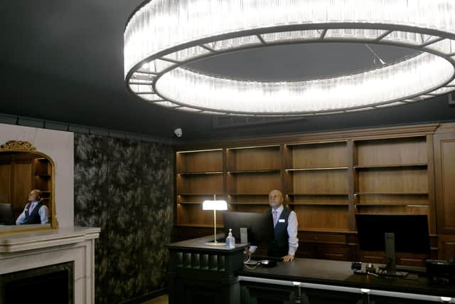 Dav Singh a Concierge  at the  Queens Hotel In Leeds,  in the new reception area at the  hotel , getting ready for reopening.