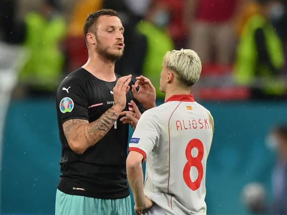 APOLOGY ISSUED - Marko Arnautovic speaks with North Macedonia and Leeds United defender Ezgjan Alioski at the end of the UEFA EURO 2020 Group C match. Pic: Getty