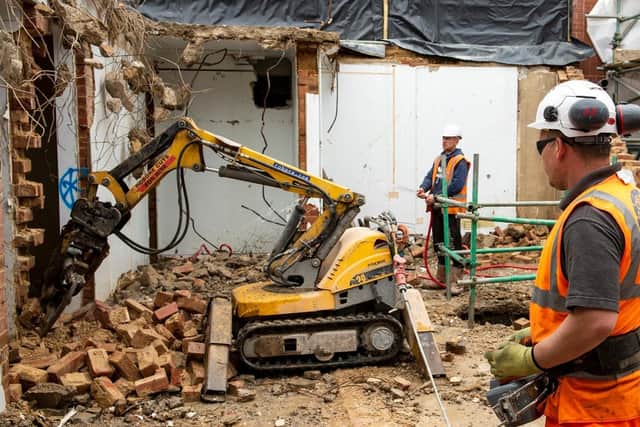 Demolition work using remote-controlled small machines on the Old Nurses Home close to LGI's Jubilee Wing.