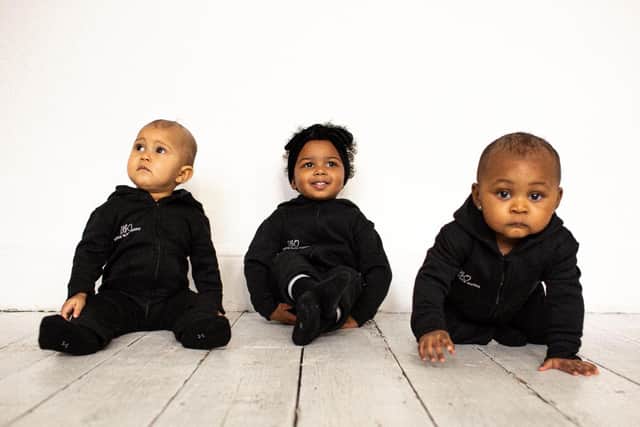 Laura's one-year-old daughter Ariyah, centre, modelling the Little Black Outfit collection
