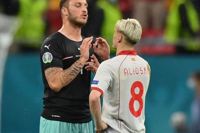 Leeds United's Gjanni Alioski and Marko Arnautovic talk during North Macedonia against Austria. Pic: Getty