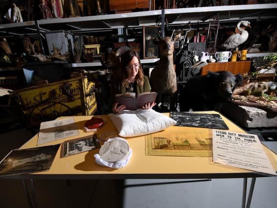 Archivist Errin Hussey with objects at Leeds Discovery Centre (photo: Simon Hulme)