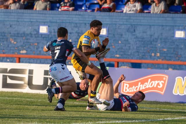 Jordan Turner forces his way past Mason Luino, Lee Kershaw and Max Jowitt to score for Tigers. Picture by Tony Johnson.