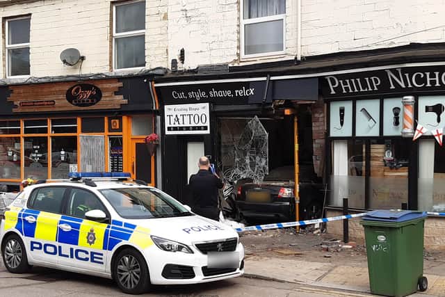 A man has been arrested after a car crashed through a window in Bradford Road.