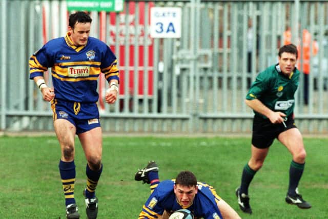 Francis Cummins, left, looks on as Kevin Sinfield scores agianst Widnes in 1999. Picture by Gary Longbottom.