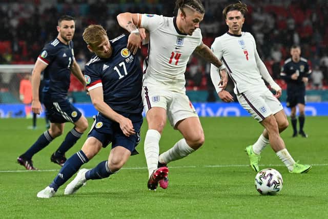 SELECTION DEBATE: Leeds United's England international midfielder Kalvin Phillips, centre, holds off Scotland's Stuart Armstrong, left, as Three Lions substitute Jack Grealish, right, looks on. Photo by Justin Tallis - Pool/Getty Images.