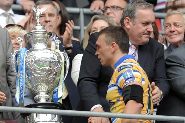 What might have been: 
Kevin Sinfield glances at the Challenge Cup as he collects his losers medal in 2010. Five times he made that walk until finally getting his hands on the trophy in 2014. (Picture: Steve Riding)