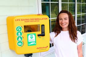 Judith Ward in front of the newly-installed defibrillator at Clariant Sports Ground. Photo: Redorow