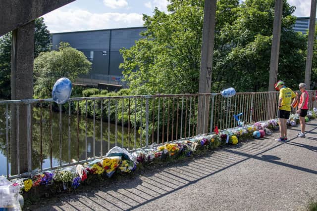Following the tragedy flowers and cards paying tribute to the popular teen have been left at railing overlooking the scene. Photo credit: Tony Johnson/JPIMedia