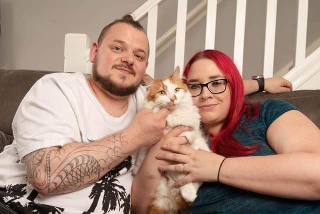 Bruno the cat with his owners Caroline and Damon. Picture: Richard Walker/PA Wire