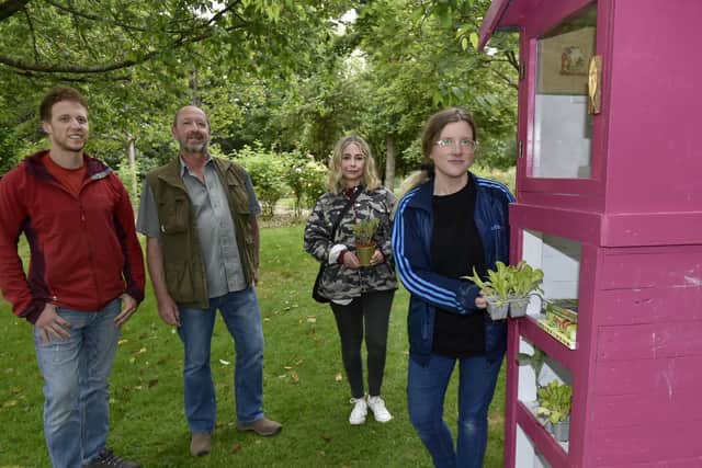 Sarah Priestley of CA Spaces puts plants in the Little Veg Library in Chapel Allerton Park. Looking on are Jamie and Tim Waddington of Leeds Woodcrafters and Angie Talbot of CA_Spaces.