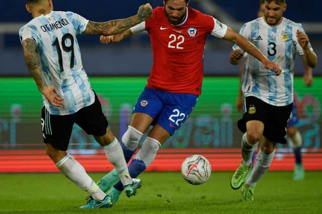 FACING THE BEST: Stoke-born Blackburn Rovers forward but now Chile international Ben Brereton vies for the ball with Argentina's Nicolas Otamendi, left, and Nicolas Tagliafico, right, during this summer's Copa America. Photo by MAURO PIMENTEL/AFP via Getty Images.
