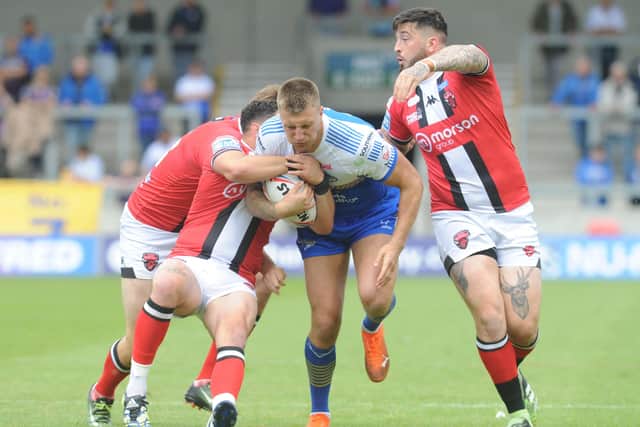 Leeds Rhinos' Alex Mellor takes on the Salford Red Devils' defence. Picture: Steve Riding.