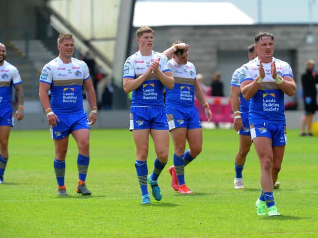Rhinos players - led by James Donaldson, right, applaud their fans after the win at Salford. Picture by Steve Riding.