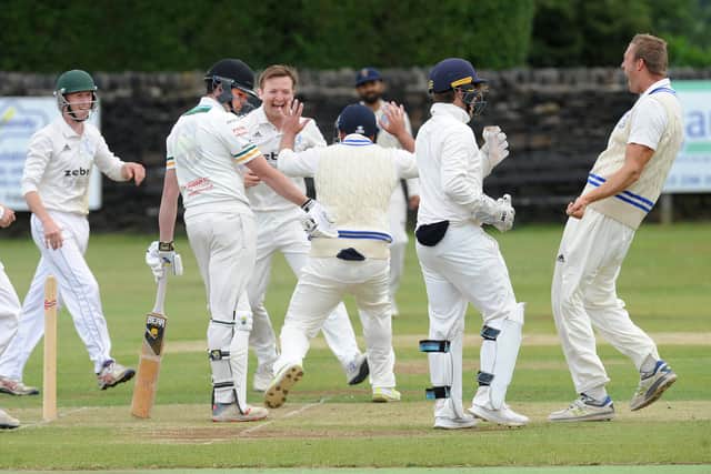 Farsley's players celebrate after dismissing Pudsey St Lawrence's Mark Robertshaw for 0 in the Bradford League on Saturday. Picture: Steve Riding.