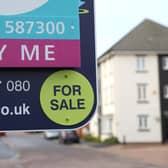 Library image of  an estate agent's board outside a house for sale