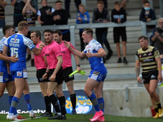 Jack Broadbent celebrates one of his tries against Leigh, with Tom Briscoe and Liam Sutcliffe. Picture by Jonathan Gawthorpe.