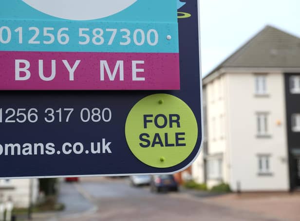 Library image of  a general view of a estate agent's board outside a house for sale