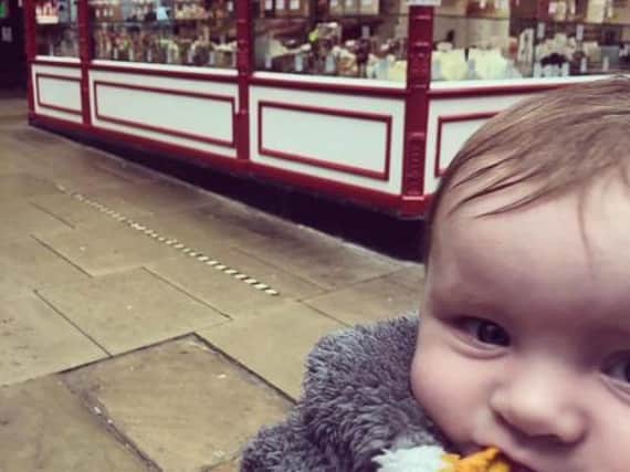 A mum has praised a Kirkgate Market trader for his 'little act of kindness' after he help her teething daughter Aria, six months, by giving her a chunk of dried mango. Photo provided by mum Amy Louise Betteridge.