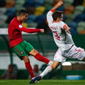 OBVIOUS CREDENTIALS: Leeds United's Diego Llorente, right, kept out Portugal star Cristiano Ronaldo, left, in a goalless draw in Lisbon back in October 2020 but has yet to play a minute for Spain at the Euros. Photo by CARLOS COSTA/AFP via Getty Images.