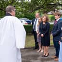 Reverend Dr Jonathan Pritchard (far left) greets relatives of Captain Sir Tom Moore ahead of burying Sir Tom's ashes at his family's grave in Morton Cemetery, Riddlesden