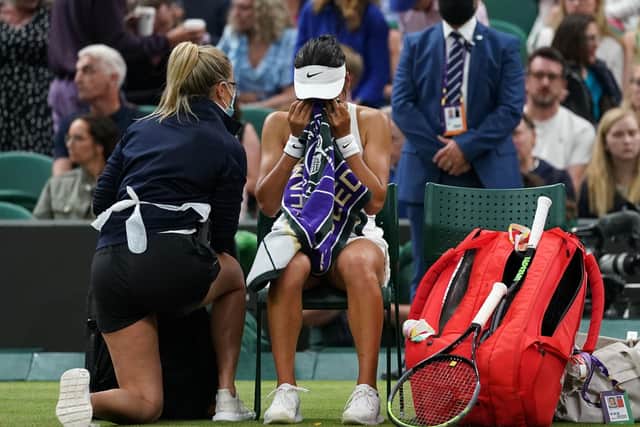 Emma Raducanu appears to be struggling as she consults a medical assistant during her Court One match against Ajla Tomljanovic. Picture: Adam Davy/PA