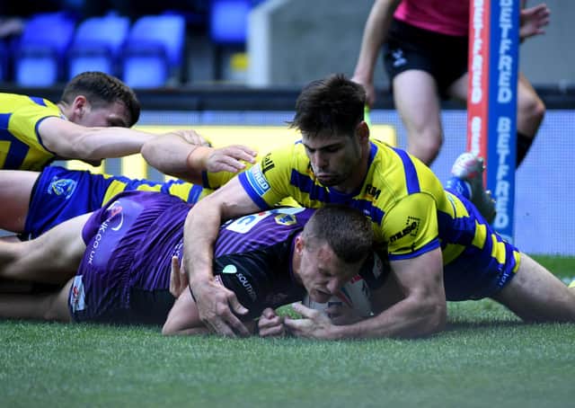 Handy: Rhinos winger Ash Handley gets the ball down for a try against Wolves. Picture: Simon Hulme