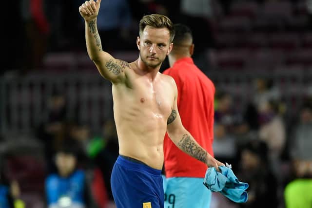 THUMBS UP: From former Barcelona and Croatia international midfield star Ivan Rakitic, above, for Junior Firpo's switch from Camp Nou to Leeds United. Photo by LLUIS GENE/AFP via Getty Images.