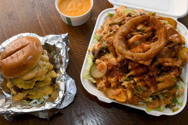 Big Buns at Brewery Tap. Pictured The Big burger, OG chips, onion rings and nacho cheese dips.
