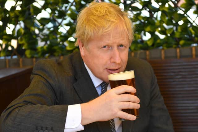 Prime Minister Boris Johnson sips a pint in the beer garden during a visit to The Mount pub and restaurant in Wolverhampton, West Midlands, on the local election campaign trail. Picture date: Monday April 19, 2021 (photo: PA).