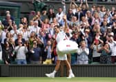 Roger Federer applauds the fans as he leaves the field after defeat to Hubert Hurkacz.