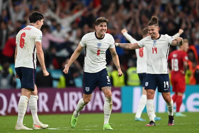 Harry Maguire, John Stones, and Kalvin Phillips of England celebrate following their team's victory in the UEFA Euro 2020 Championship Semi-final match between England and Denmark at Wembley Stadium (Picture: Andy Rain - Pool/Getty Images)