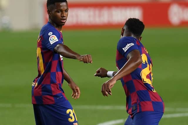 MESSAGE: From Barcelona and Spain teen sensation Ansu Fati, left, to new Leeds United left back Junior Firpo, right. Photo by Alex Caparros/Getty Images.