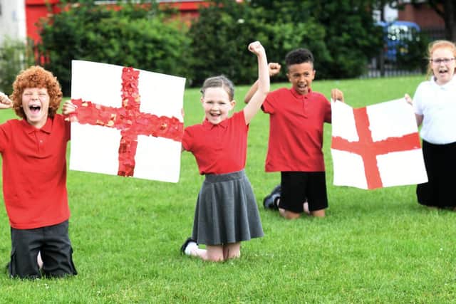 Year 3 and 4 pupils at Whingate Primary school in Leeds (L-R)Noah Stainforth and Sophia Hurley, both aged eight and Theo Willie and Emily Grace Radcliffe, both aged nine, with their England flags.
