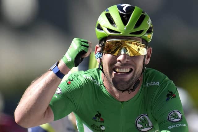 Record equaller: Mark Cavendish celebrates winning his 34th stage of the Tour de France to pull alongside Eddy Merckx. Picture: Christophe Ena/AP