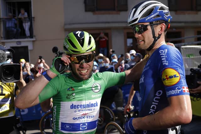 Winning feeling: Britain's Mark Cavendish, wearing the best sprinter's green jersey, celebrates with a teammate after winning the thirteenth stage of the Tour de France. Picture: Stephane Mahers/AP