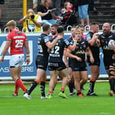 Grant Millington, with ball, celebrates his early try for Tigers in their loss to Salford. Picture by Jonathan Gawthorpe.