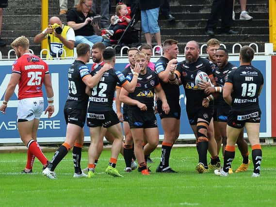 Grant Millington, with ball, celebrates his early try for Tigers in their loss to Salford. Picture by Jonathan Gawthorpe.