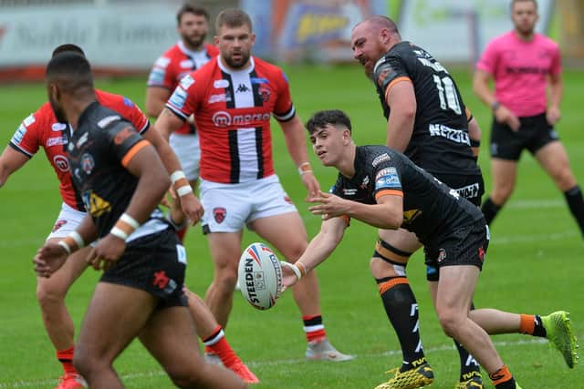 Tigers debutant Cain Robb offloads. Picture by Jonathan Gawthorpe.