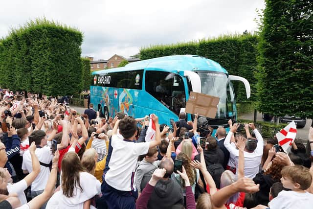 Fans applaud as the England team bus leaves a hotel in Hertfordshire.