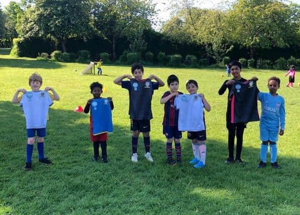 Young footballers from Leeds Hyde Park FC with received new kit donated following burglary.