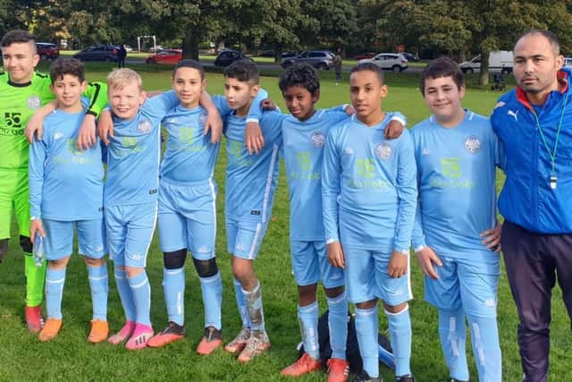 Leeds Hyde Park FC founder Adel Chermiti with young footballers.