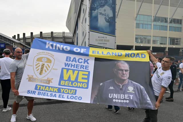 Leeds United supporters hold up a large banner as they gather outside Elland Road to celebrate the club's return to the Premier League after 16 years. PIC: Getty