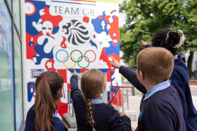 Kids from Holy Family school admire new Olympic mural by Leeds-based artist Nicolas Dixon.