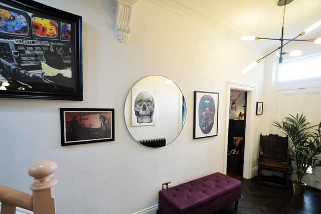 The couple wanted to create a punk/rock feel in the hallway, which they accomplished with their choice of artwork. Photo: Jonathan Gawthorpe