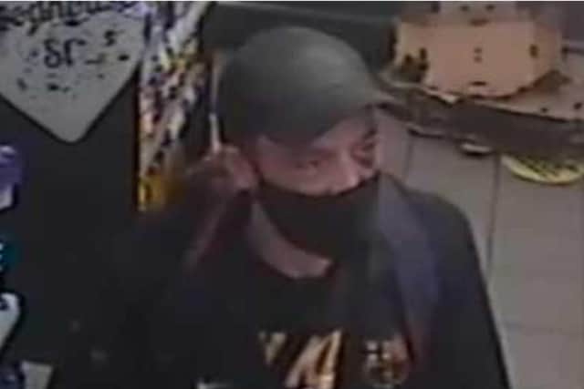 Police are appealing for information to help identify a suspect over a violent robbery at a shop in Leeds last year.