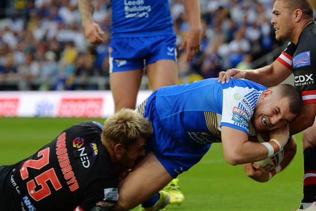 Cameron Smith is pulled down just short of the line by his former Rhinos teammate Jack Ormondroyd. Picture by Jonathan Gawthorpe.