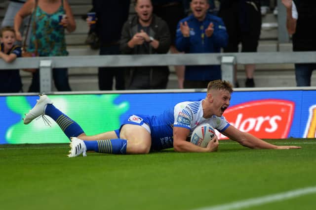 In the corner: 
Rhinos' Harry Newman slides in for the first try.

Picture: Jonathan Gawthorpe